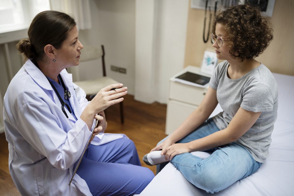 Doctor engaged in a conversation with a young adult female patient